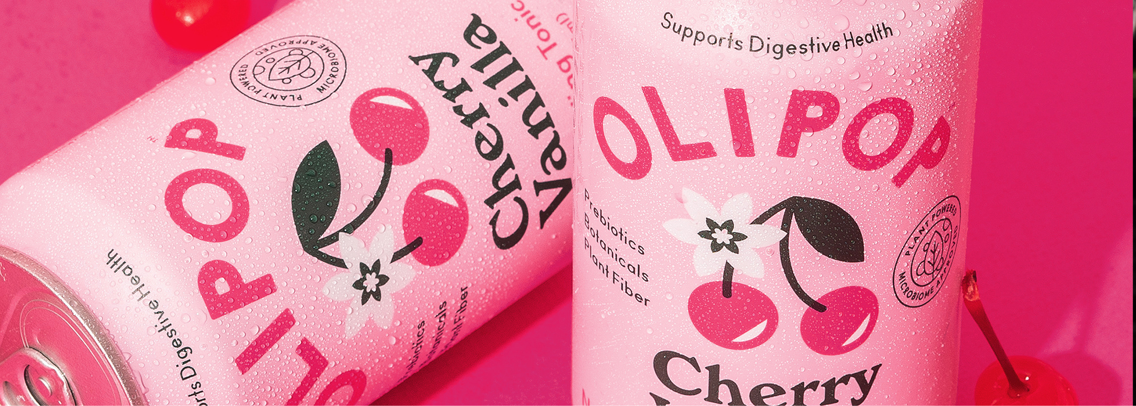 Two cans of glistening Cherry Vanilla OLIPOP.